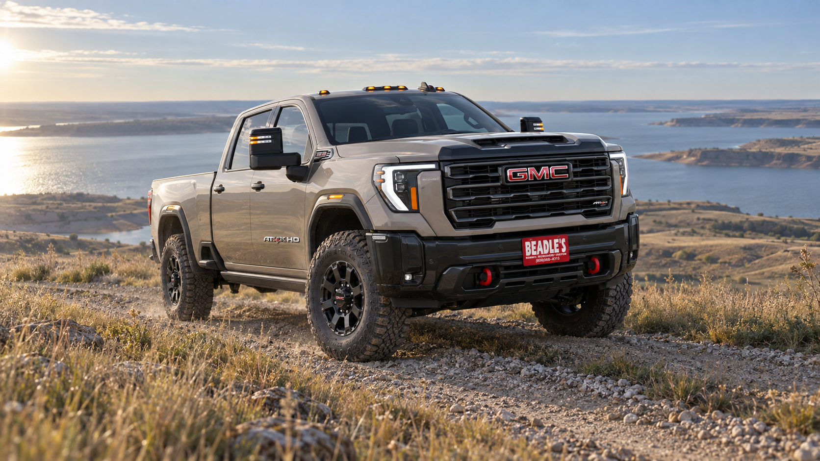 2027 GMC Sierra 2500 HD AT4X in Coastal Dune on a two-track above Lake Oahe, South Dakota