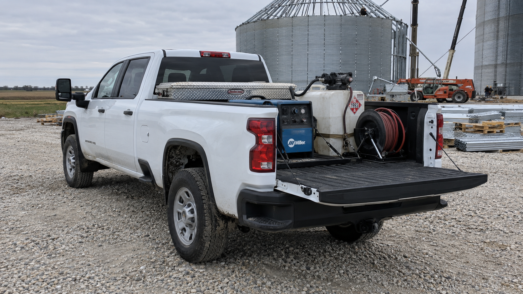 2026 GMC Sierra 2500 HD Pro work truck with a welder and toolbox at a job site near Mobridge, South Dakota