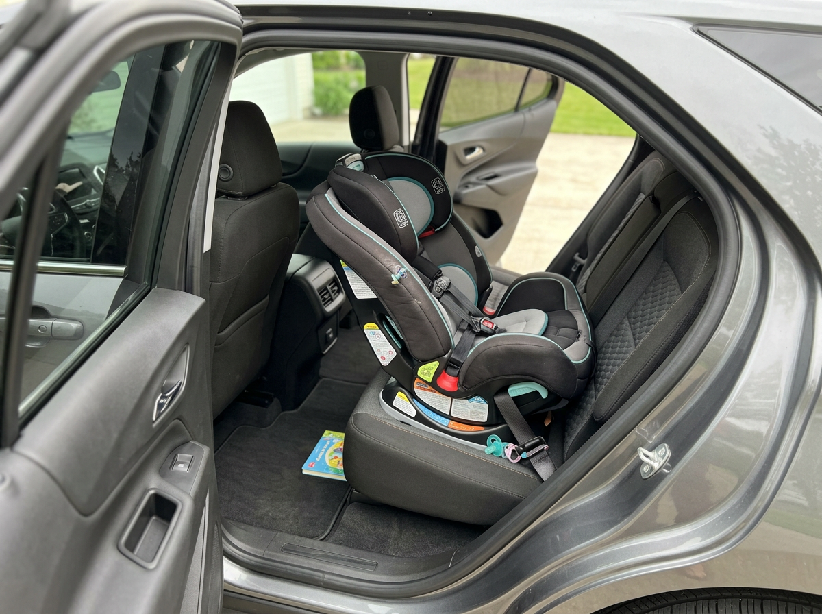 Rear seat of the 2027 Chevrolet Equinox with two child safety seats installed side by side
