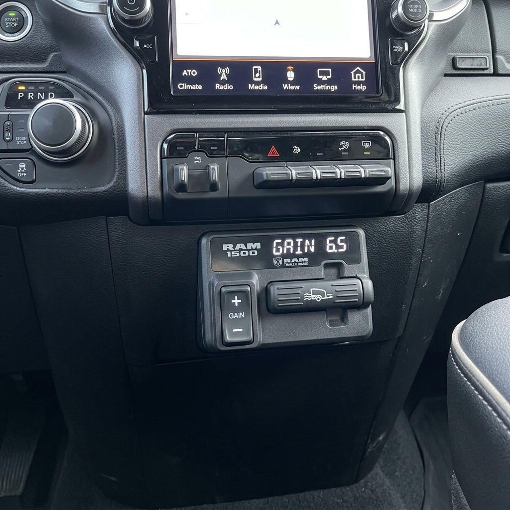RAM 1500 center console showing the integrated trailer brake controller displaying a gain of 6.5. (Representative image for illustration purposes only. Actual vehicle may vary based on trim and configuration.)