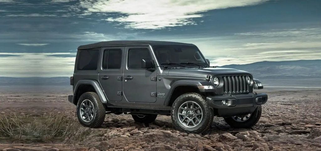 Silver 2021 Jeep Wrangler parked in front of a desert setting.