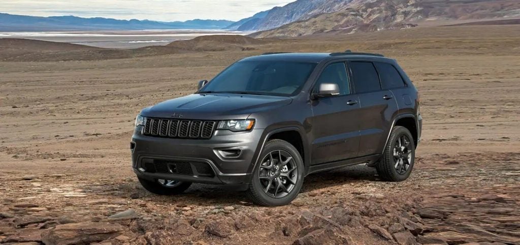 A 2021 Jeep Grand Cherokee parked in the middle of a desert field.
