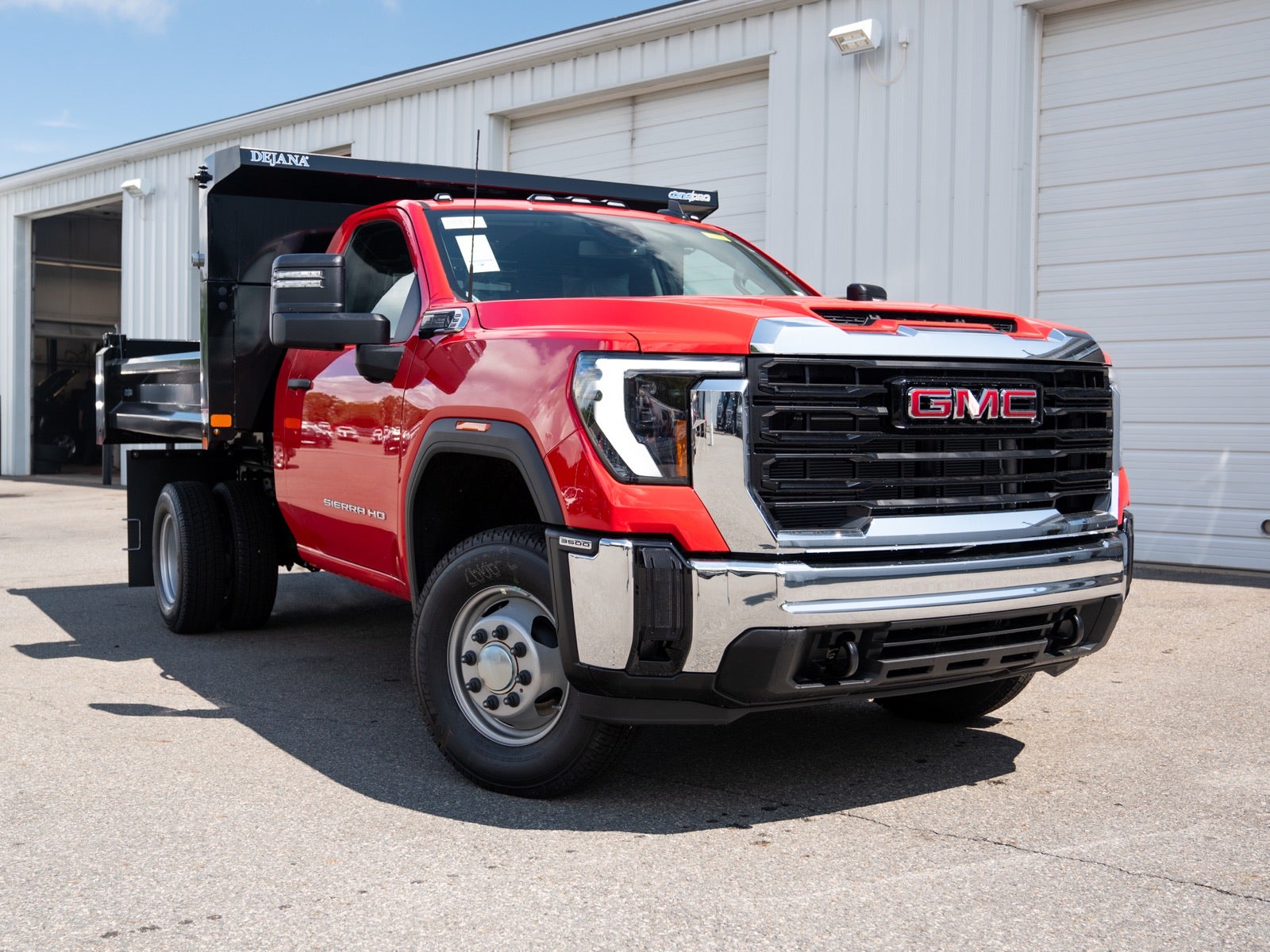 Red GMC Sierra HD with a black dump body at Marty’s