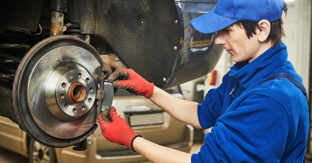Automobile brake pads replacement in car repair shop or garage