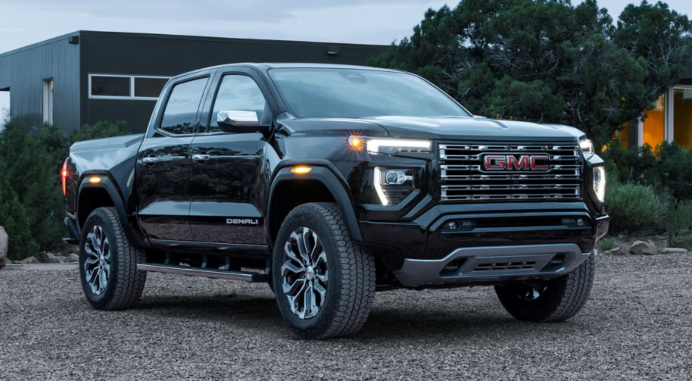 Black 2026 GMC Canyon parked in front a house