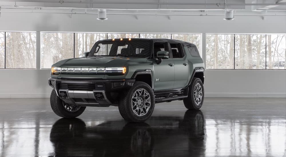 A green 2025 GMC Hummer EV is shown from the front at an angle.