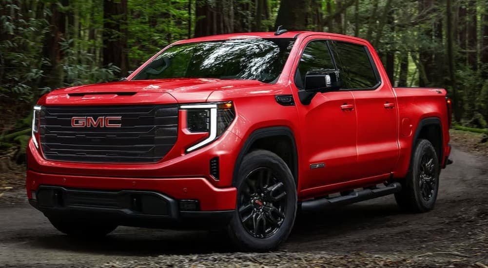 A red 2026 GMC Sierra 1500 Elevation parked offroad.