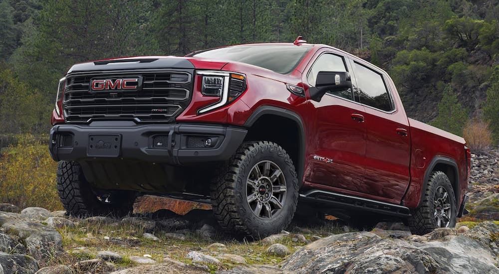 Red GMC Sierra 1500 for sale driving off-road.