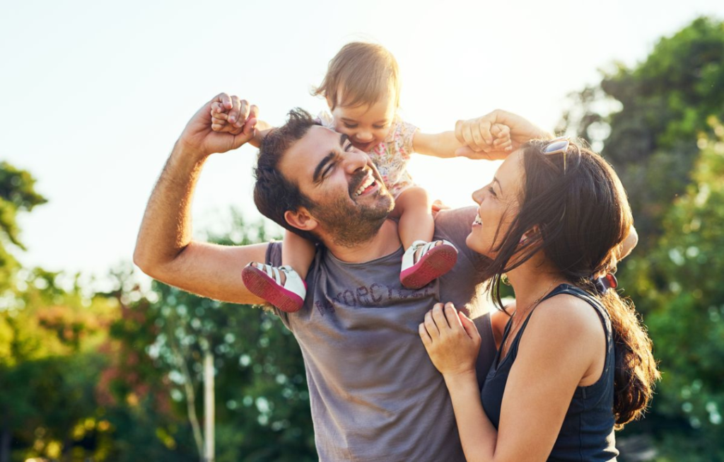 Family of three enjoying summer weather outdoors