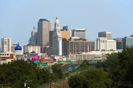The Hartford skyline at sunset, featuring the iconic Travelers Tower and the Connecticut River.