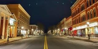 A picturesque view of Main Street in Lee, Massachusetts, lined with historic buildings and shops