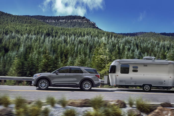 Gray Ford Explorer towing a trailer