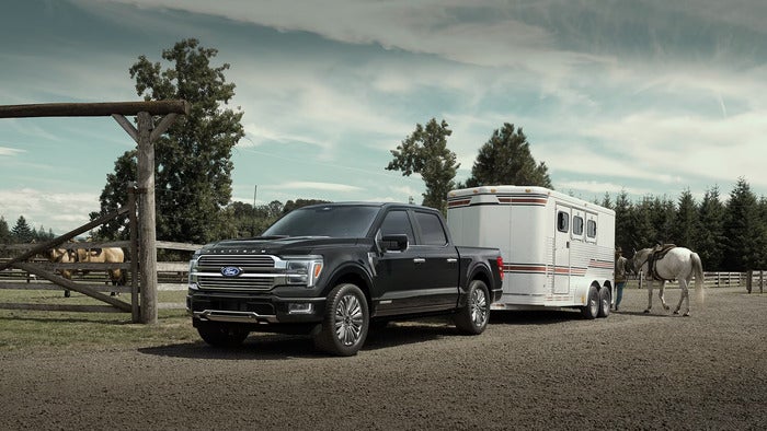 Black Ford F-150 parked at a farm