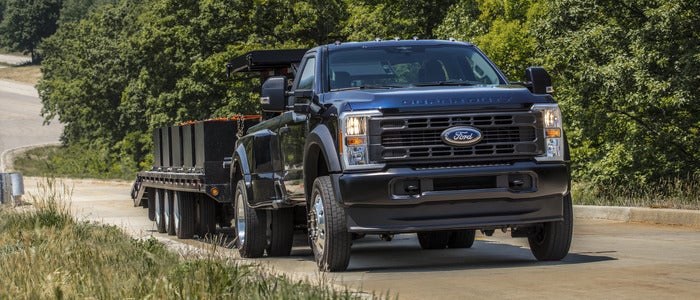 Black 2025 Ford F-450 towing a trailer