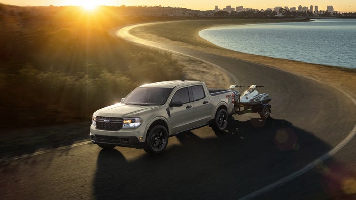 Gray Ford Maverick towing jet skis