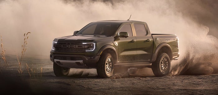 Green Ford Ranger driving in the dirt