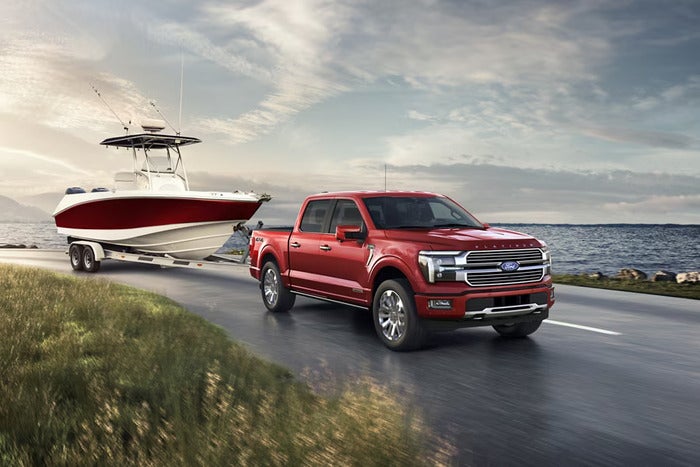 Red Ford F-150 towing a boat