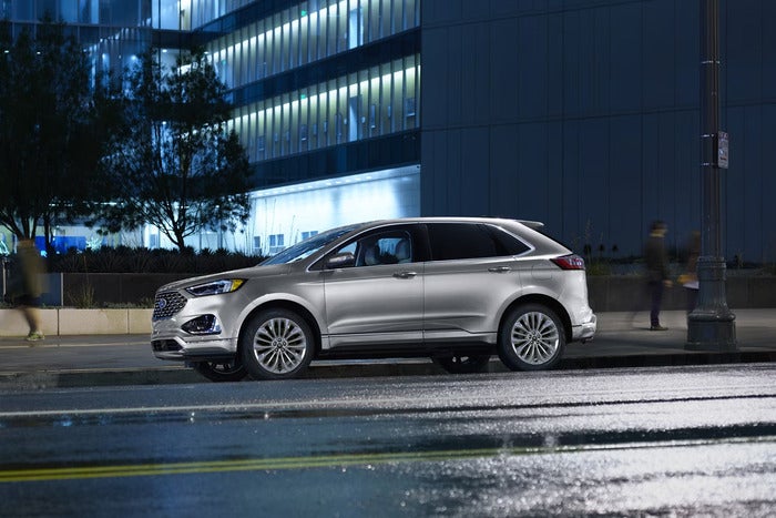 Silver Ford Edge parked on the side of the street