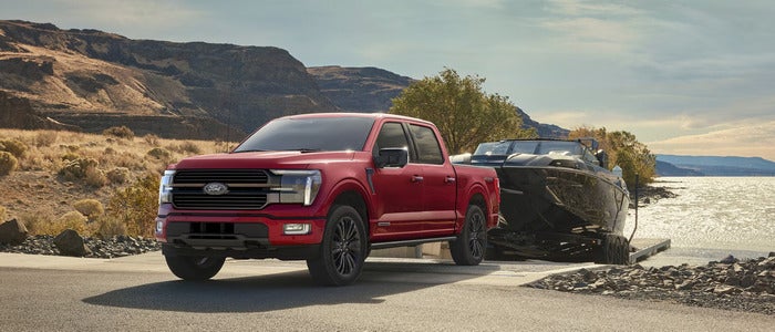 Red Ford F-150 towing a boat out of the water