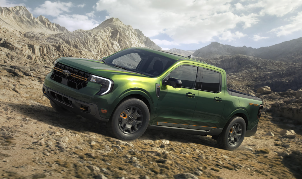 Green 2025 Ford Maverick Tremor driving up rocky terrain