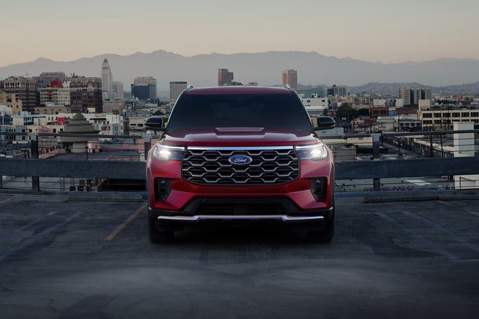 Red Ford Explorer facing the front, parked in parking space