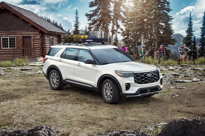 White Ford Explorer parked in the dirt