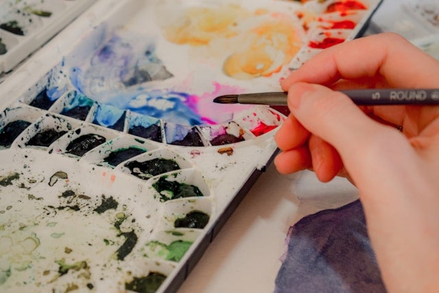 Person holding paint brush