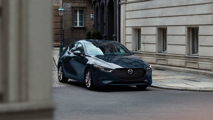 Black Mazda3 Hatchback driving on the street