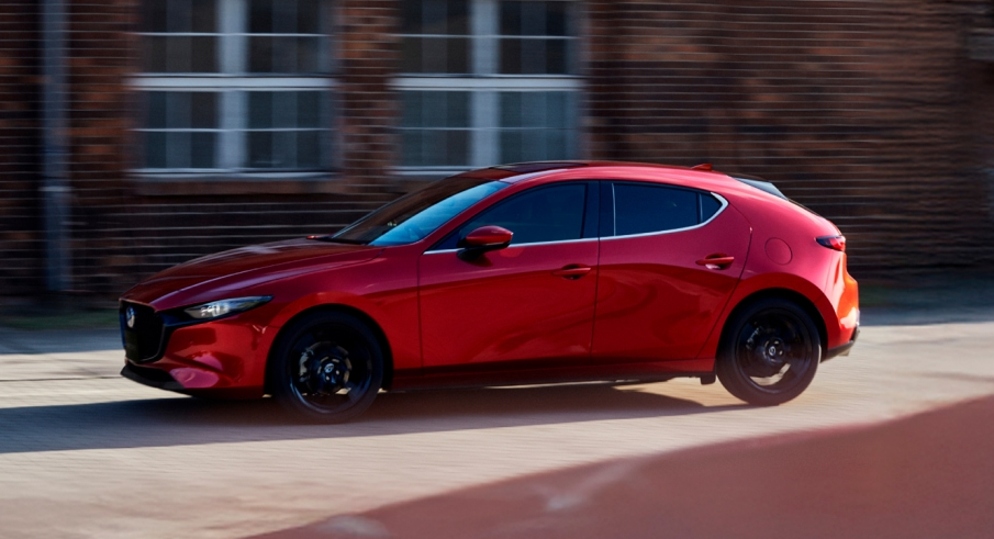 Red 2026 Mazda3 Hatchback driving
