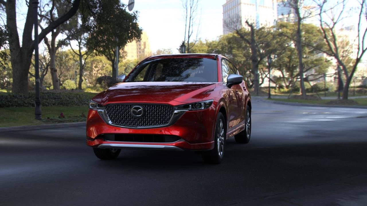 Red Mazda CX-5 driving on the street