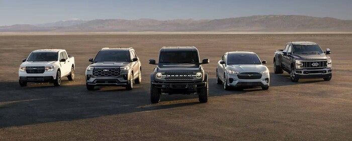 5 ford models driving down a plain