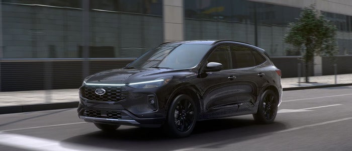 Black 2025 Ford Escape driving on the road