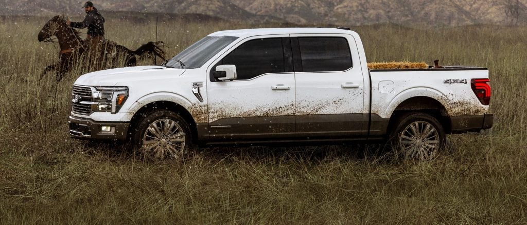 White 2026 Ford F-150 driving in farmland