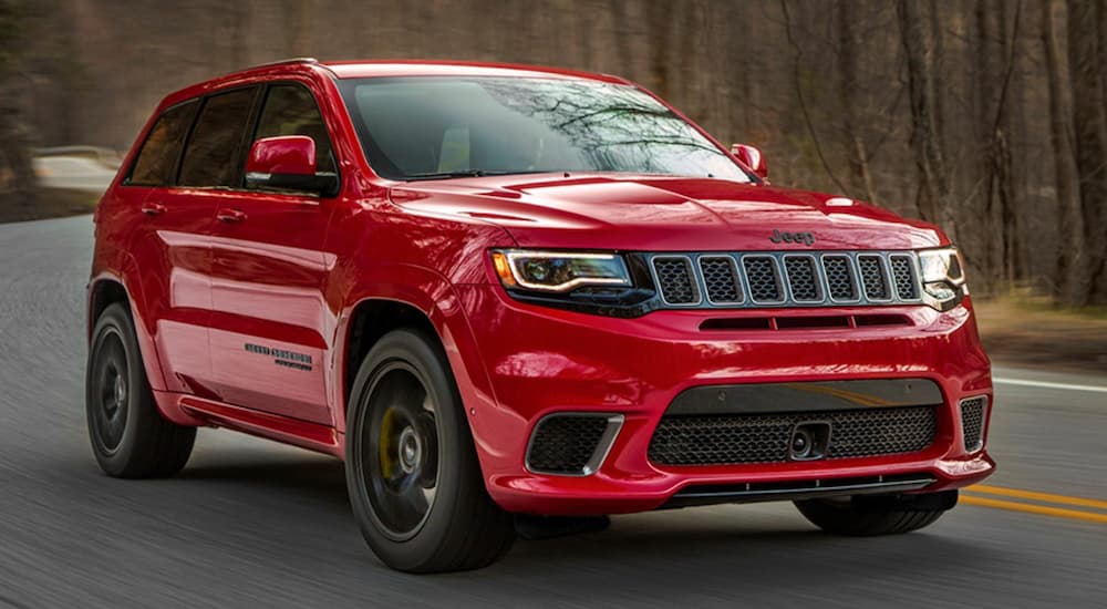 A red 2020 Jeep grand Cherokee Trailhawk driving.
