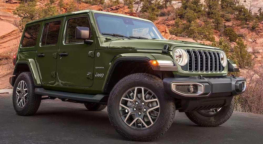 A green 2024 Jeep Wrangler for sale from the front.