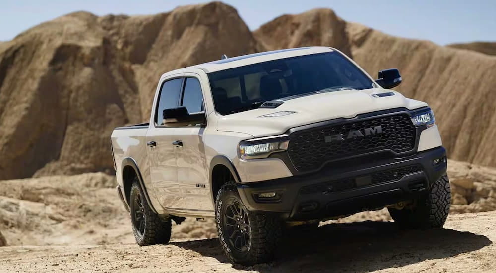 White 2025 Ram 1500 Rebel driving off-road.