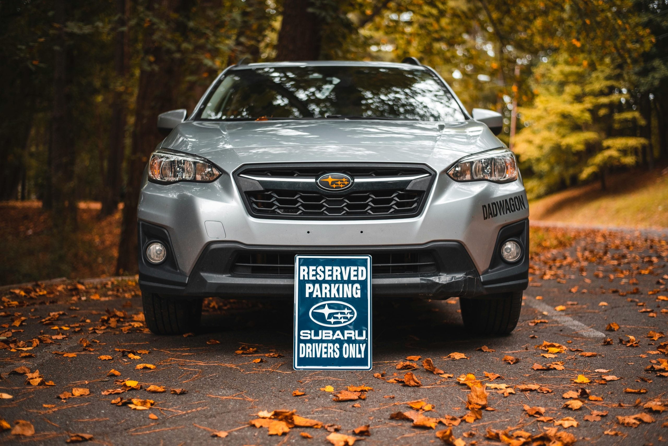 A Reserved Parking Signage near the Silver Subaru Crosstrek