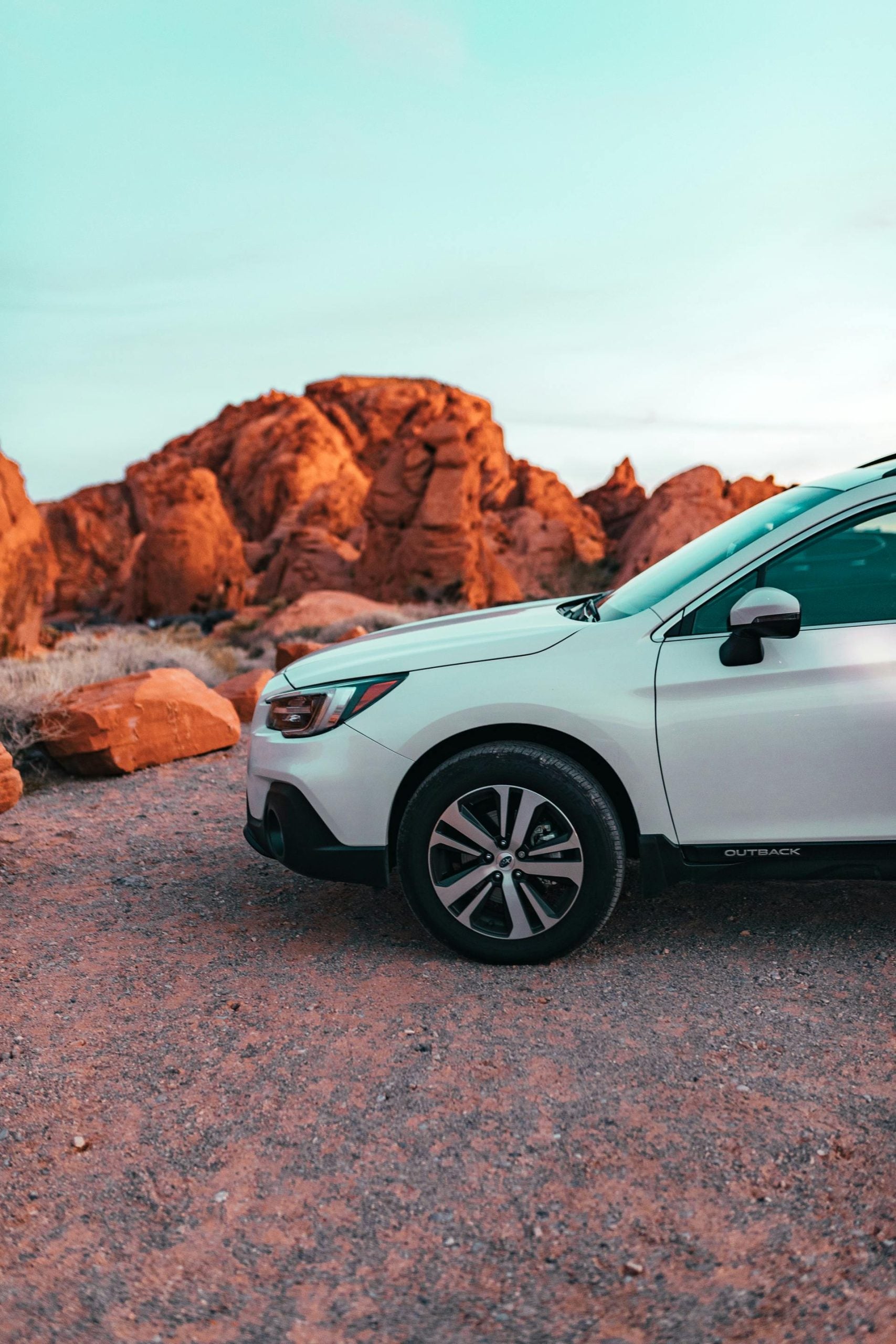 A White Vehicle Parked on Dirt Road