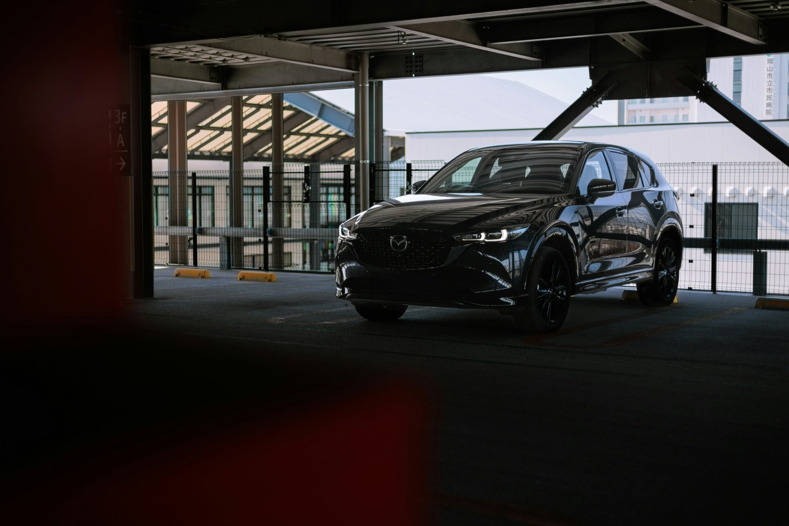 A black car parked in a parking garage
