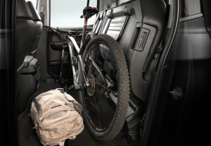 A bicycle and a backpack packed into the cabin of a 2025 Honda Ridgeline by lifting the back seat near Indianapolis, Indiana