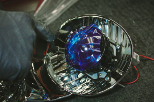 A service technician working on a car's headlights near Indianapolis, Indiana