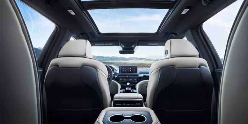 A luxurious Acura MDX interior with leather seats, a touchscreen display, and a sunroof.