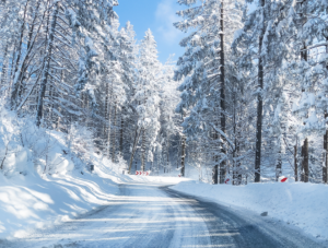 A snowy road with part of the pavement uncovered near Indianapolis, Indiana