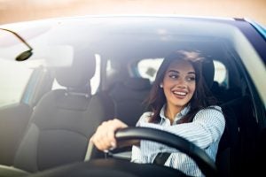 A woman test driving a fuel-efficient Acura model in Indianapolis, IN.