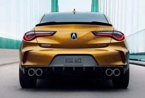 A gold Acura TLX driving on a bridge near Indianapolis, Indiana