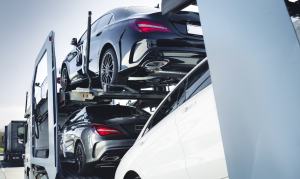 A batch of new car being delivered via truck to a dealership near Fishers, Indiana