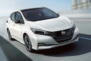 A 2024 Nissan Leaf driving down a city road near Fishers, Indiana