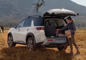 A person taking things out of the trunk of a 2024 Nissan Pathfinder.
