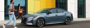 2025 Nissan Sentra parked on a city street in Indianapolis, showcasing its modern design, sporty wheels, and sleek exterior styling.