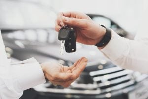 A person being handed the keys to a new 2023 Nissan Titan near Indianapolis, Indiana